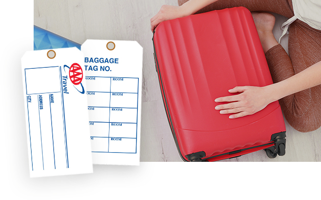 AAA travel luggage tags on a red suitcase